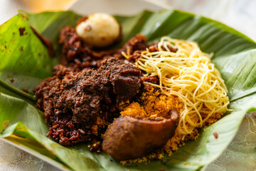 Ga kenkey with pepper sauce and fried fish, wrapped in corn husks